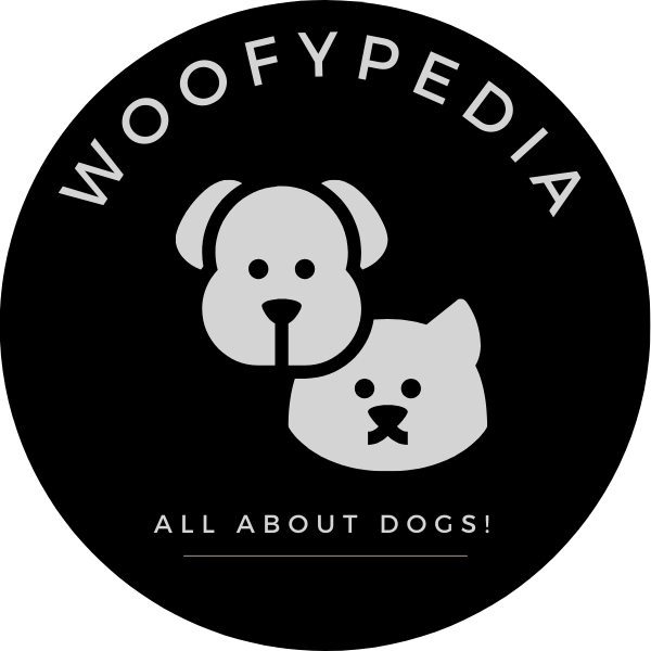 Logo of Woofypedia featuring minimalist illustrations of a dog and a cat, with the tagline 'All About Dogs!' displayed below the brand name.